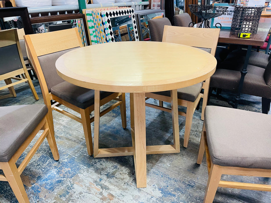 Round light wood dining table