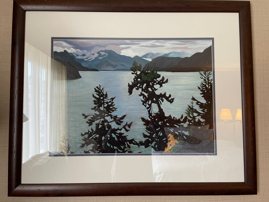 Landscape print artwork with brown wood frame