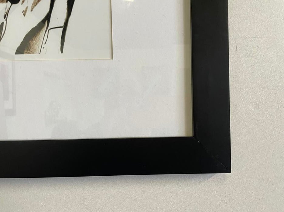 Black framed abstract artwork